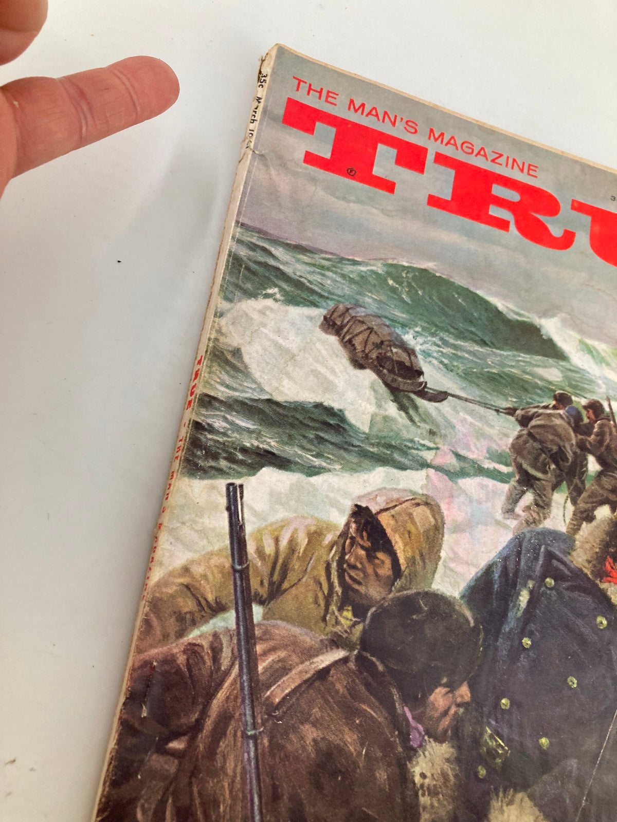 Side view of the TRUE The Man's Magazine March 1961 cover, showcasing details of the illustration and the magazine's title prominently displayed.