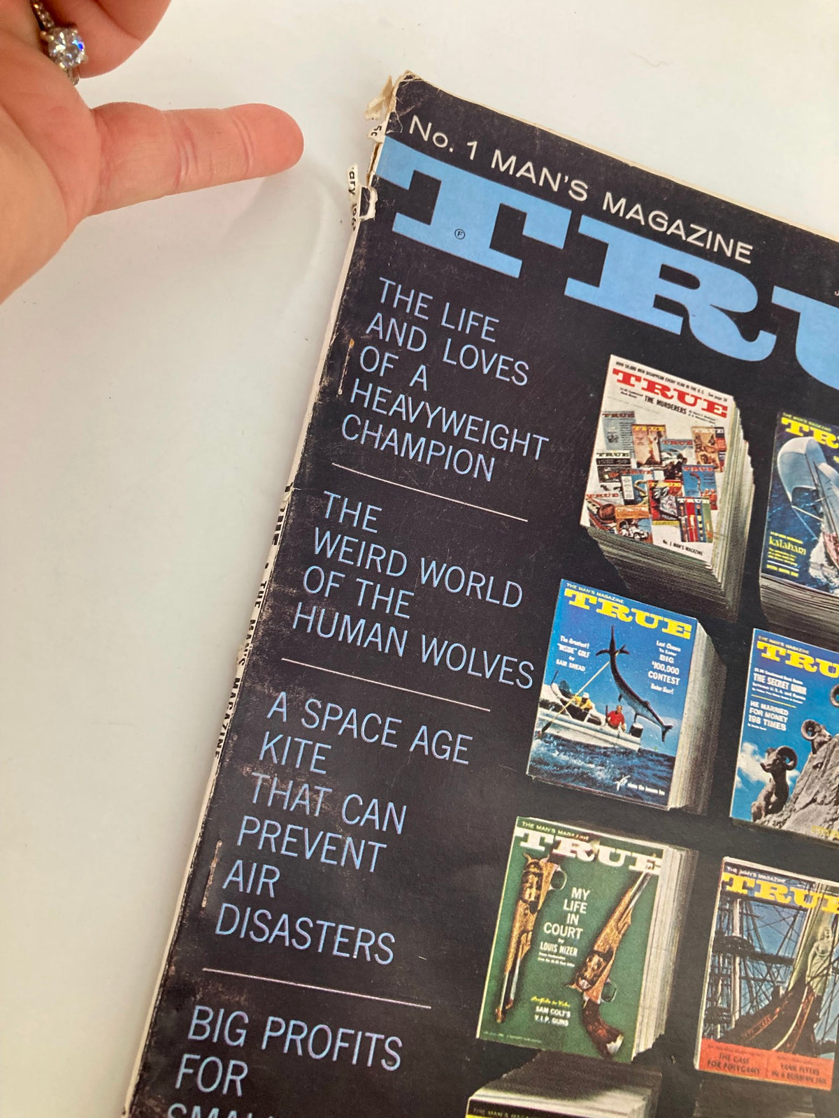 Close-up view of the cover of TRUE The Man's Magazine January 1963 highlighting text from articles such as 'The Weird World of the Human Wolves' and 'Big Profits for Small-Time Plungers'.