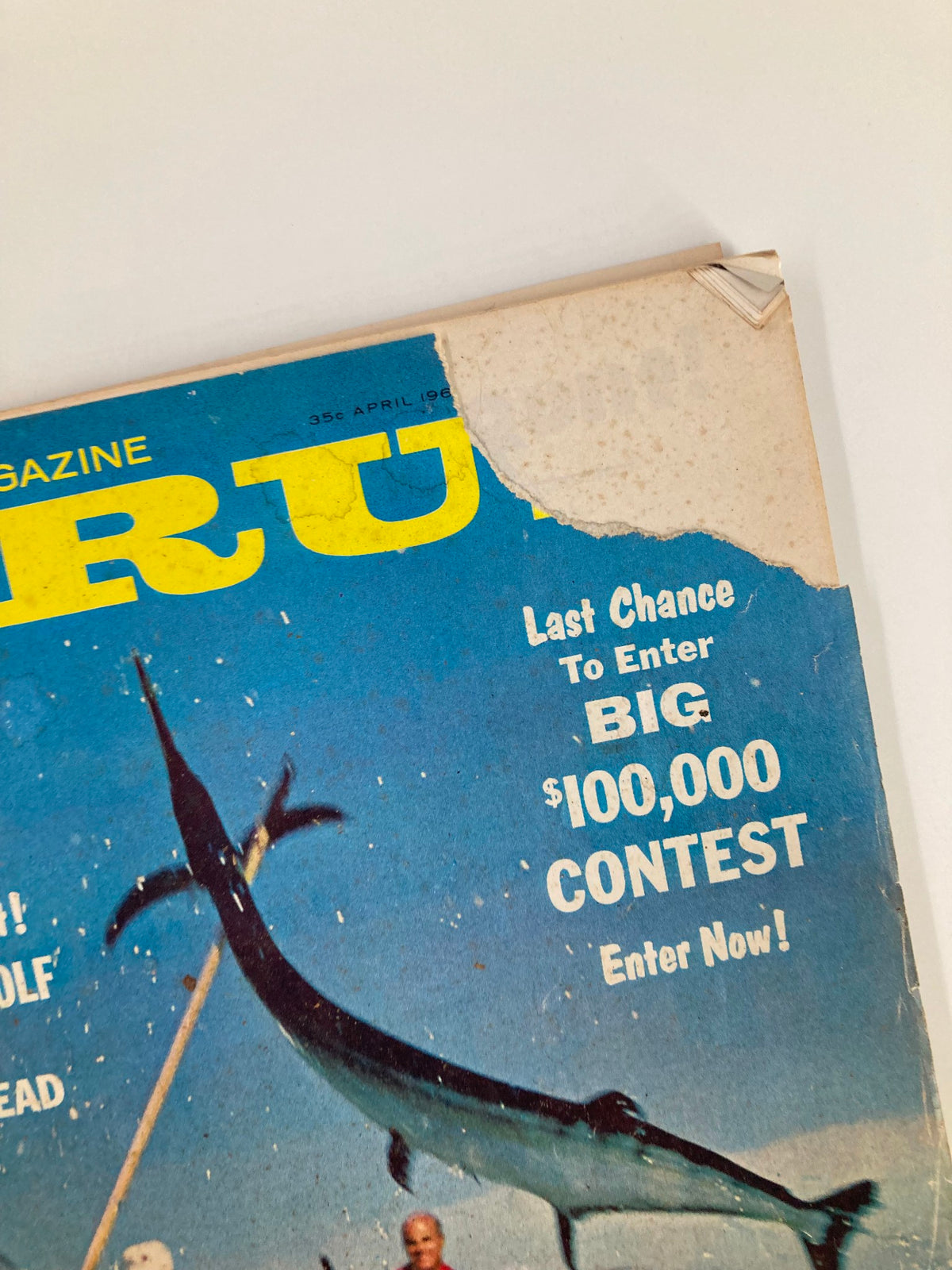 Close-up of the top corner of the TRUE The Man's Magazine April 1962 cover, showing wear and tear, along with the magazine's title and contest promotion.