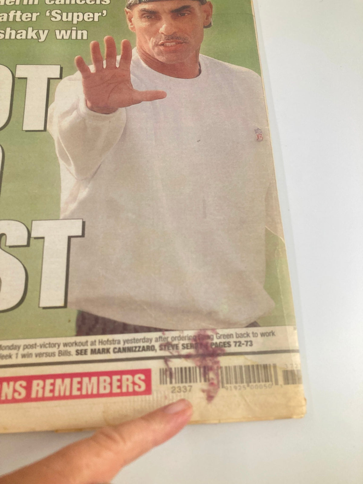Close-up of the New York Post Newspaper from September 10, 2002, showing the headline 'NOT SO FAST' and a finger pointing at the barcode on the page.
