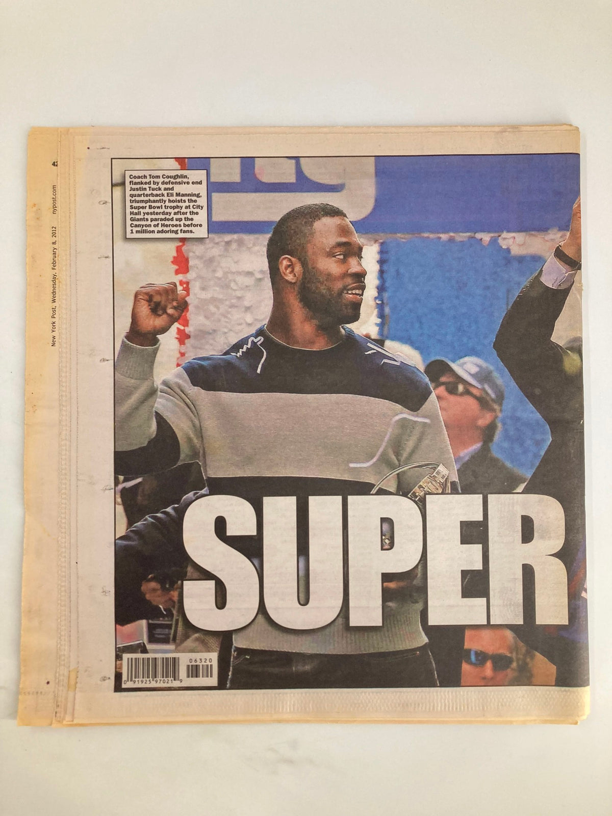 New York Post Newspaper February 8 2012 showcasing the headline SUPER in recognition of the champion Giants, featuring a celebratory image of a player raising his fist in victory.