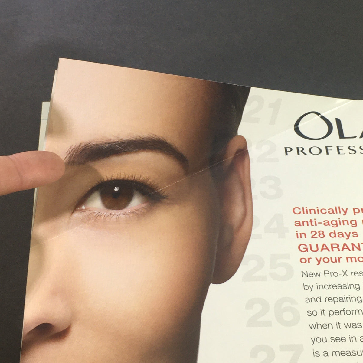 Close-up of an eye on an advertisement for Olay Pro-X, showcasing anti-aging benefits, featured in Health Magazine June 2009.