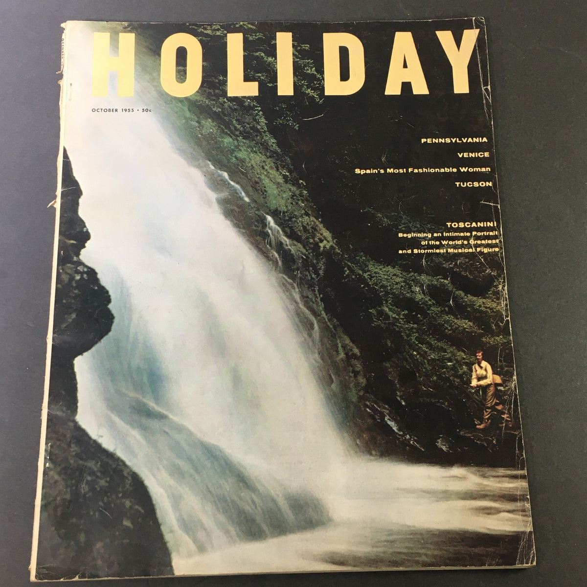 Cover of VTG Holiday Magazine October 1955 featuring stunning waterfall scenery, highlighting travel destinations like Pennsylvania, Venice, and Tucson along with an article on Toscanini.