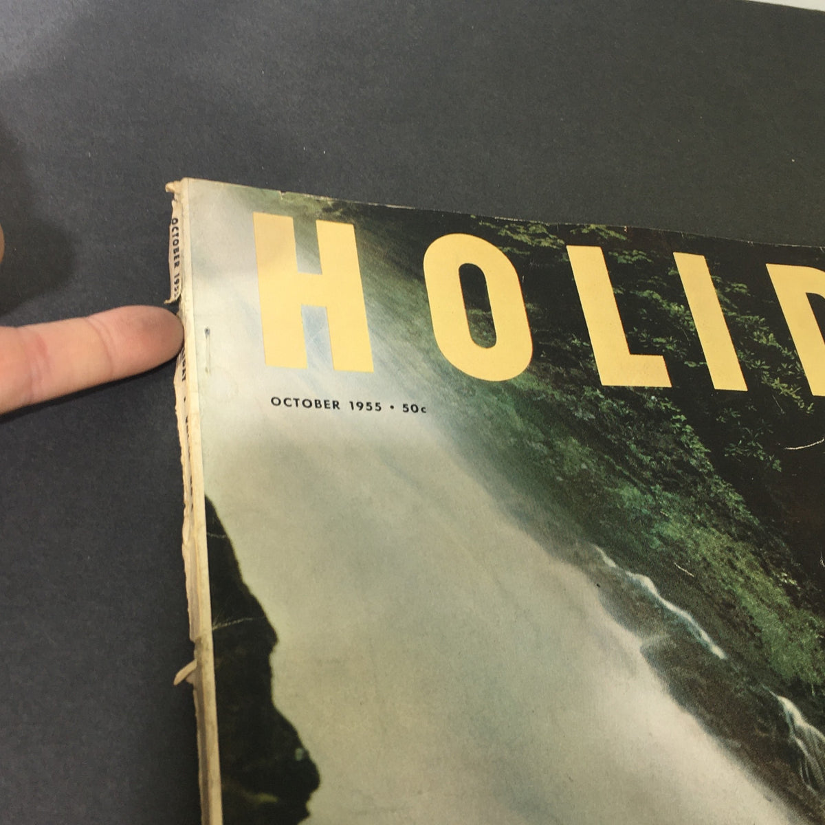 Close-up detail of the cover of VTG Holiday Magazine October 1955, showing edge wear and the publication date, showcasing its vintage charm.
