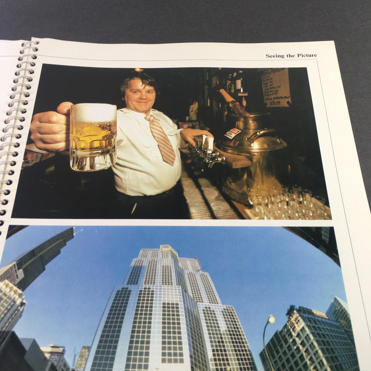Images of a bartender with a beer and a cityscape in '1982 The Camera Step-by-Step Handbook: How To Take Better Pictures', displaying examples of photography techniques.