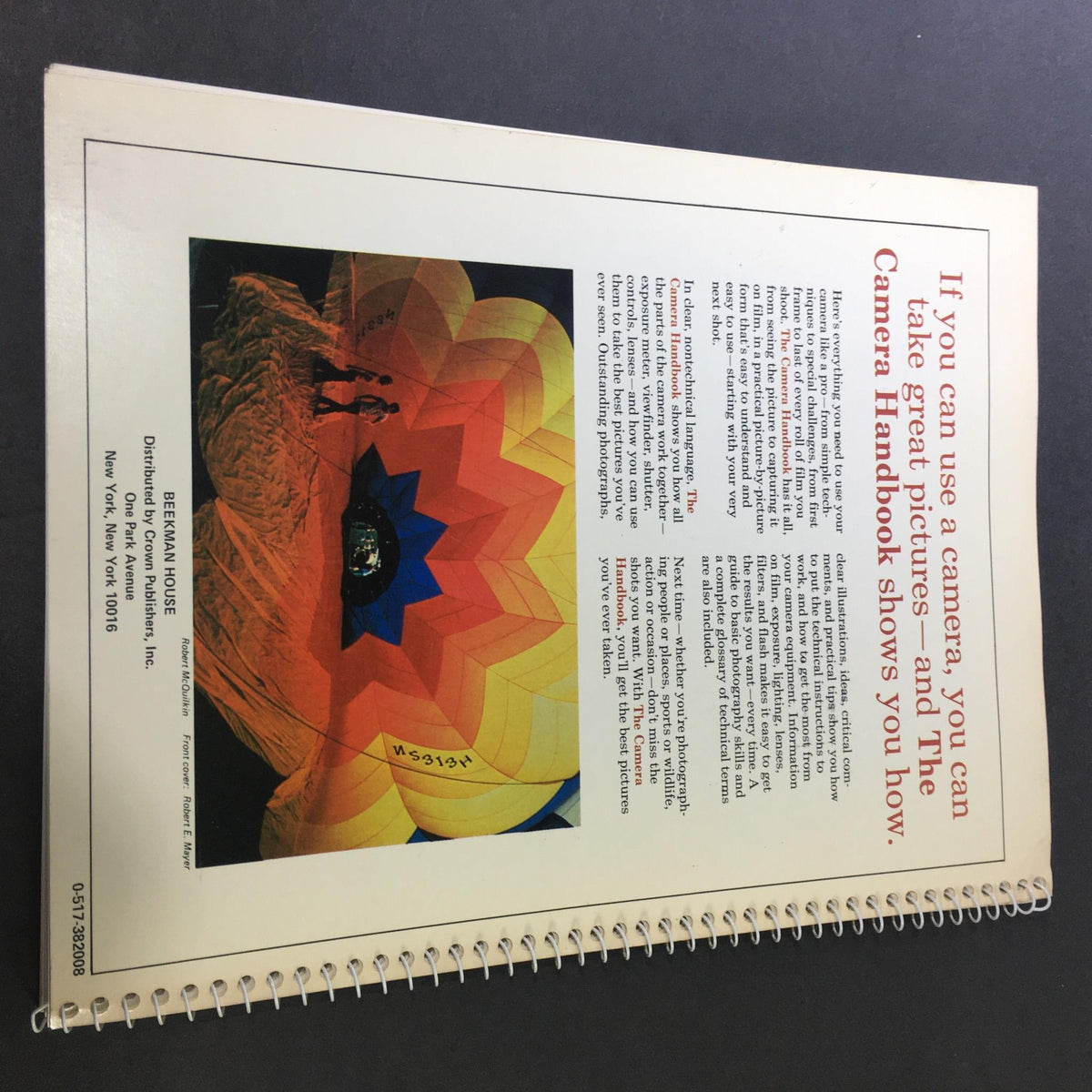 Back cover of '1982 The Camera Step-by-Step Handbook How To Take Better Pictures' featuring a vibrant image of a colorful hot air balloon with a silhouette of a person.