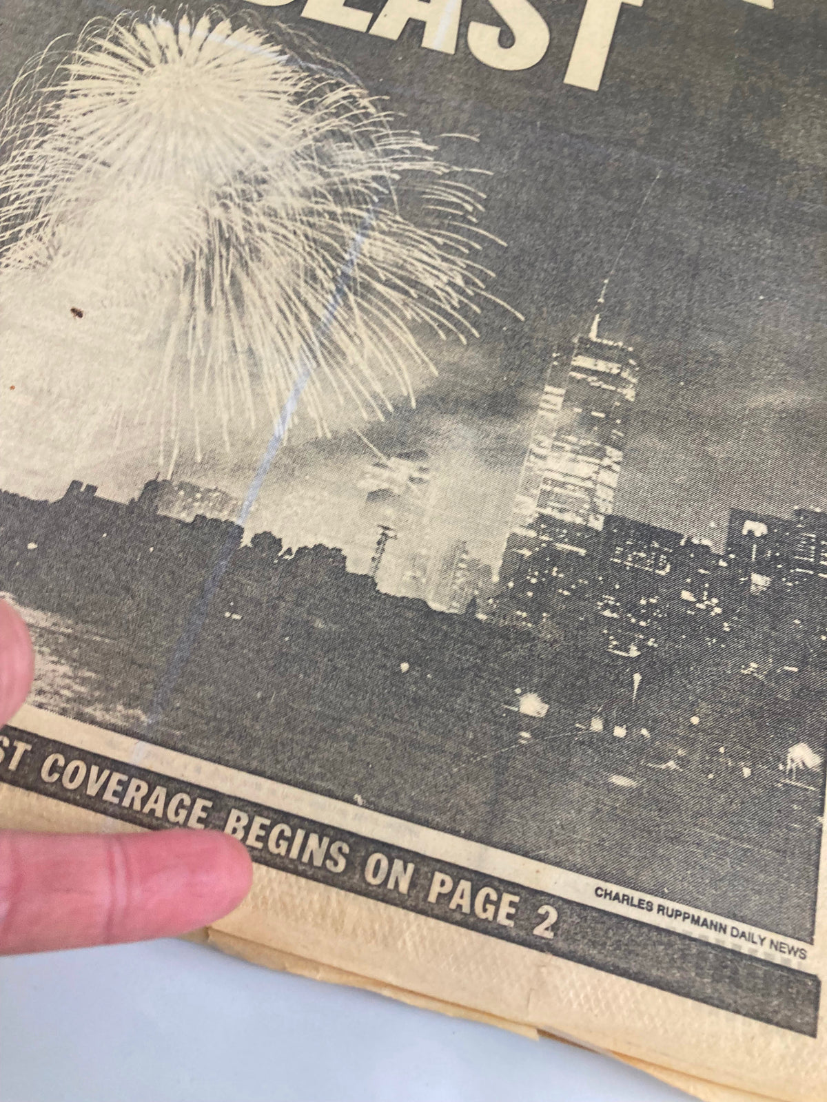 Detail view of the VTG Daily News Newspaper July 5 1986 highlighting 'Coverage Begins on Page 2' alongside fireworks imagery.