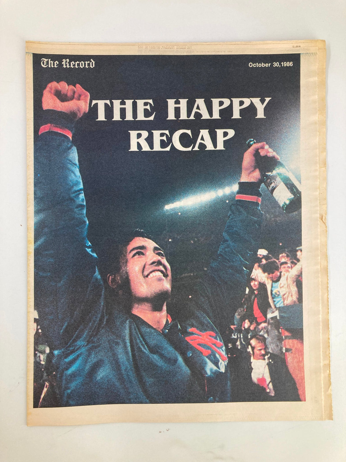 Vintage newspaper cover from The Record dated October 30, 1986, featuring the title 'THE HAPPY RECAP' with an image of a celebratory fan holding a beverage.