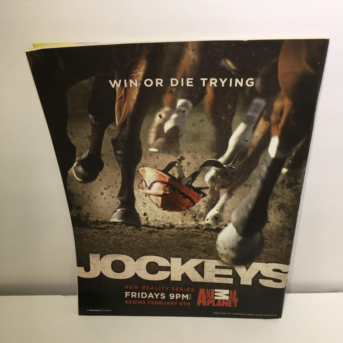 Cover of Jockeys promotional material featuring horses racing and a jockey's helmet. New reality series on Animal Planet titled 'WIN OR DIE TRYING'. Part of the TV Guide Jan 26-Feb 8 2009 Double Issue featuring Barack Obama and Michelle.
