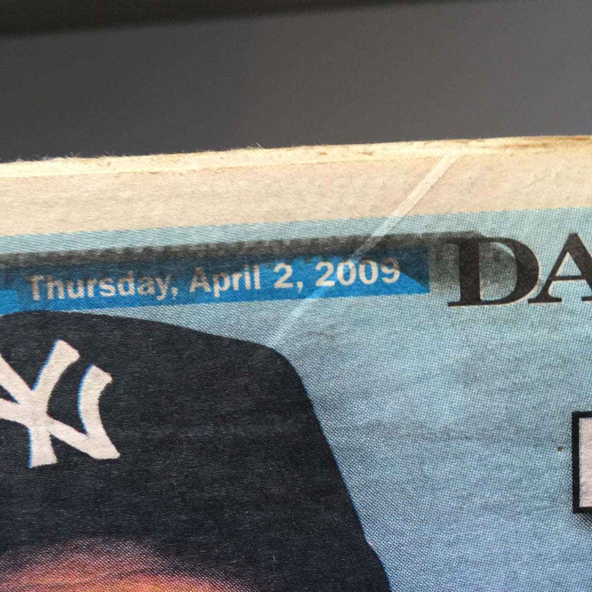 Close-up of the New York Daily News dated April 2, 2009, showcasing the publication's date in a blue banner, highlighting the historical context of the magazine.