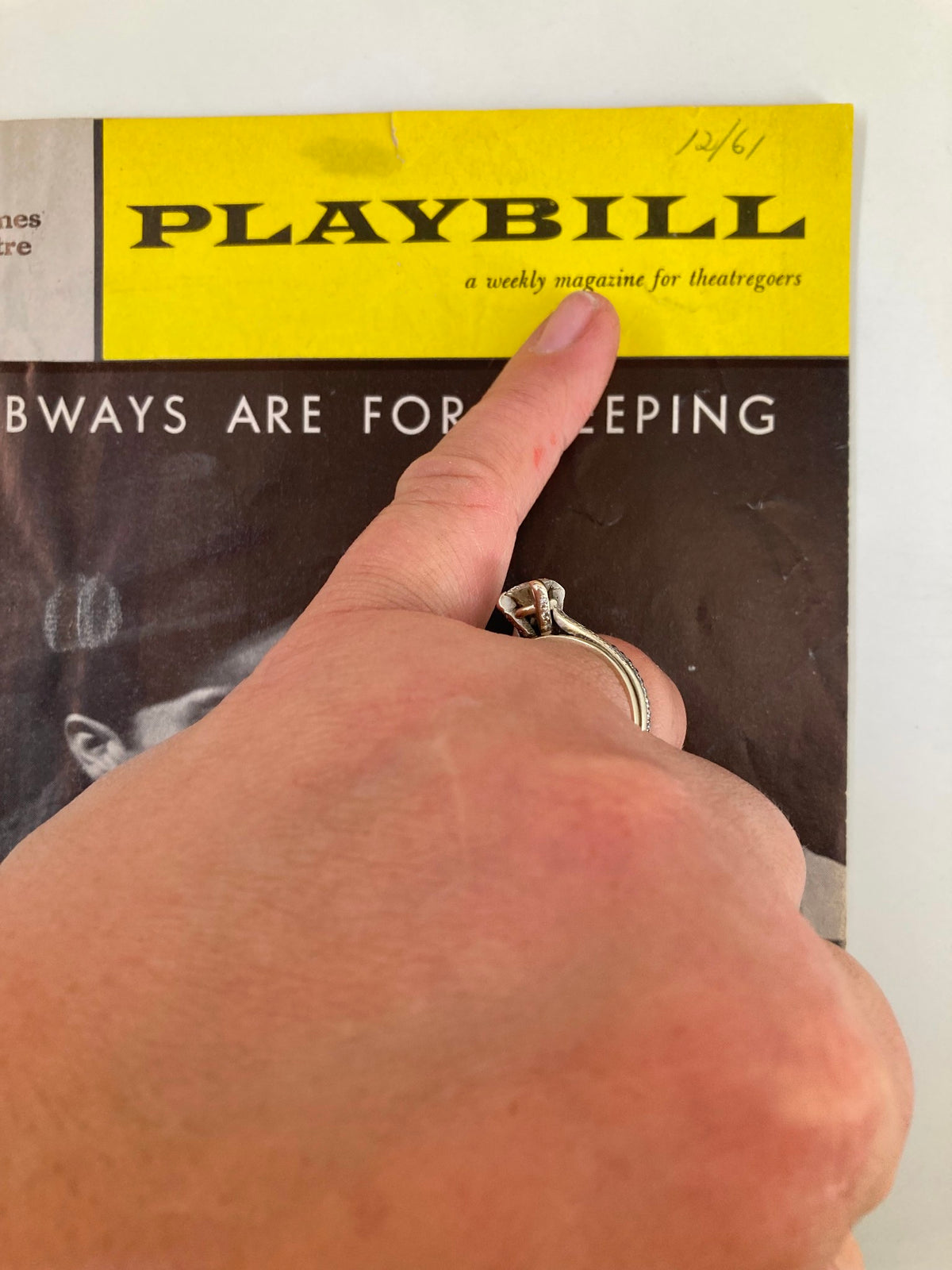 Close-up of the 1961 Playbill from St. James Theatre for 'Subways Are For Sleeping', highlighting the title and hand gesture pointing at it.