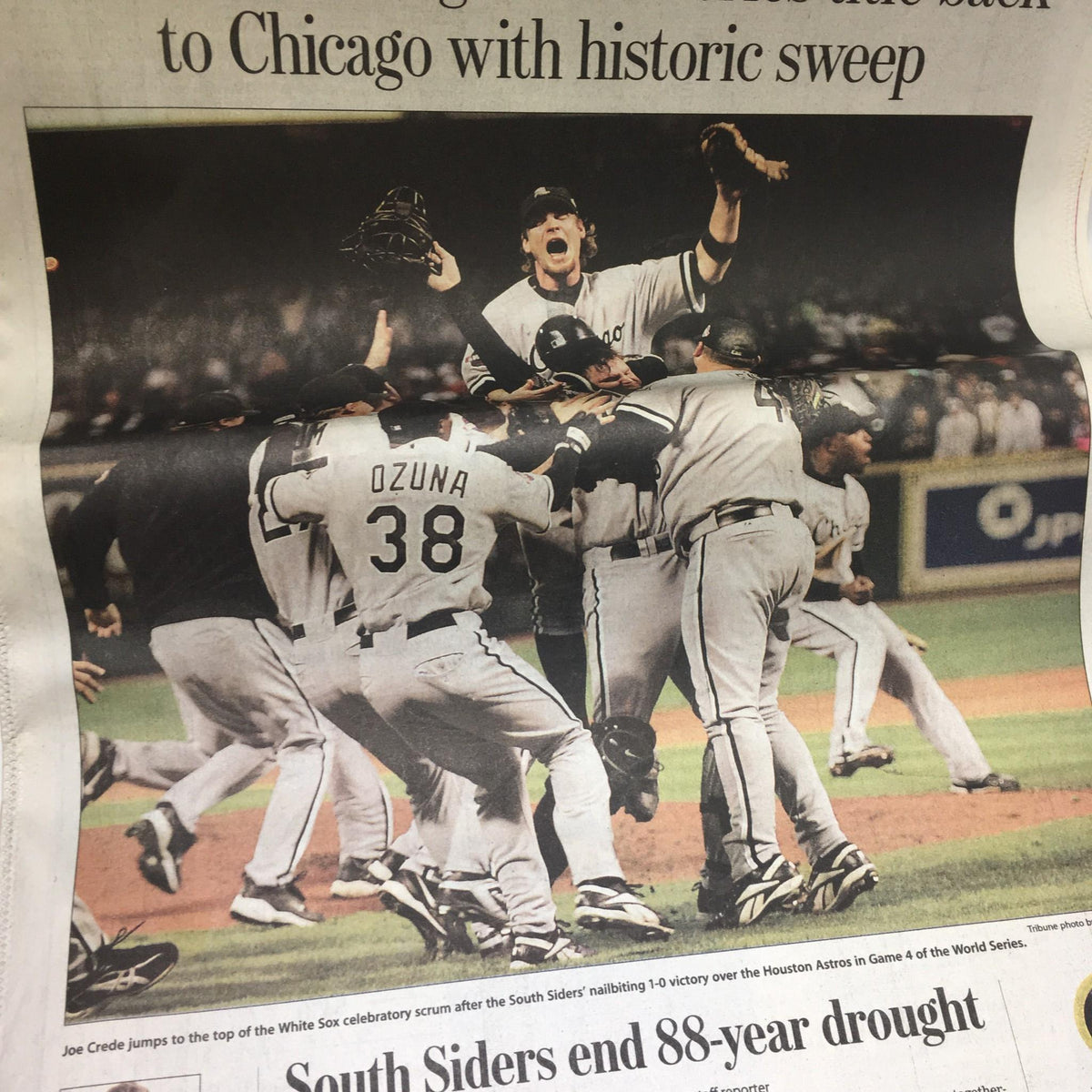 Celebration scene from the Chicago Tribune featuring the White Sox players and Joe Crede after their 2005 World Series win, with the headline 'South Siders end 88-year drought'.