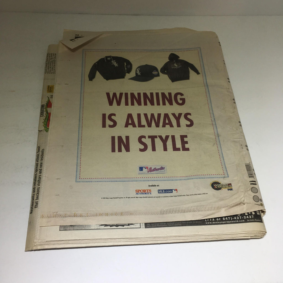 Chicago Sun-Times: Oct 26 2005 edition displaying an advertisement for apparel with the phrase 'Winning is Always in Style.' This vintage newspaper offers a glimpse into historical marketing and fashion trends.