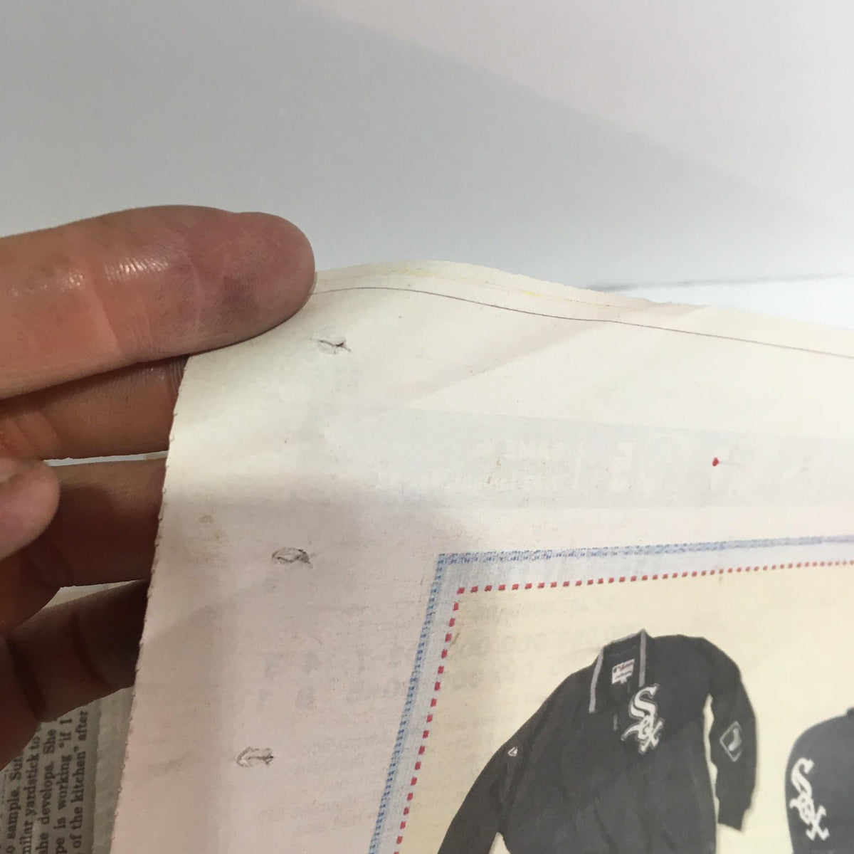 Close-up of the edge of the Chicago Sun-Times: Oct 26 2005 edition, showing minor wear and detailing. This image highlights the newspaper's vintage condition, suitable for collectors.