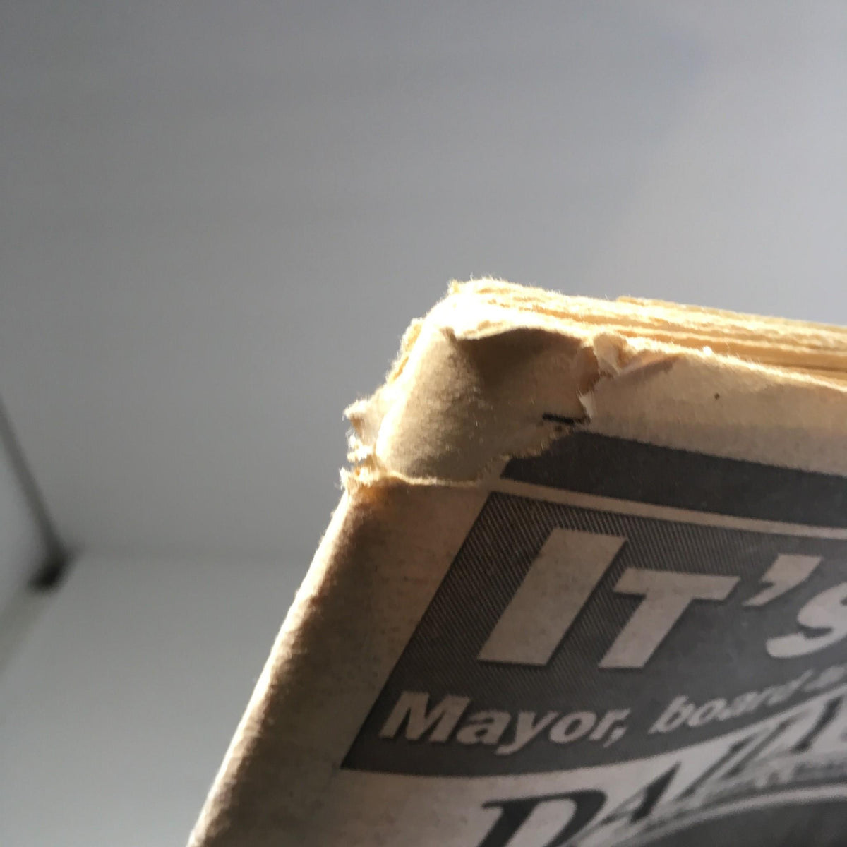 Close-up of the edge of the NY Daily News from October 7, 1995, showing mild wear and tear.