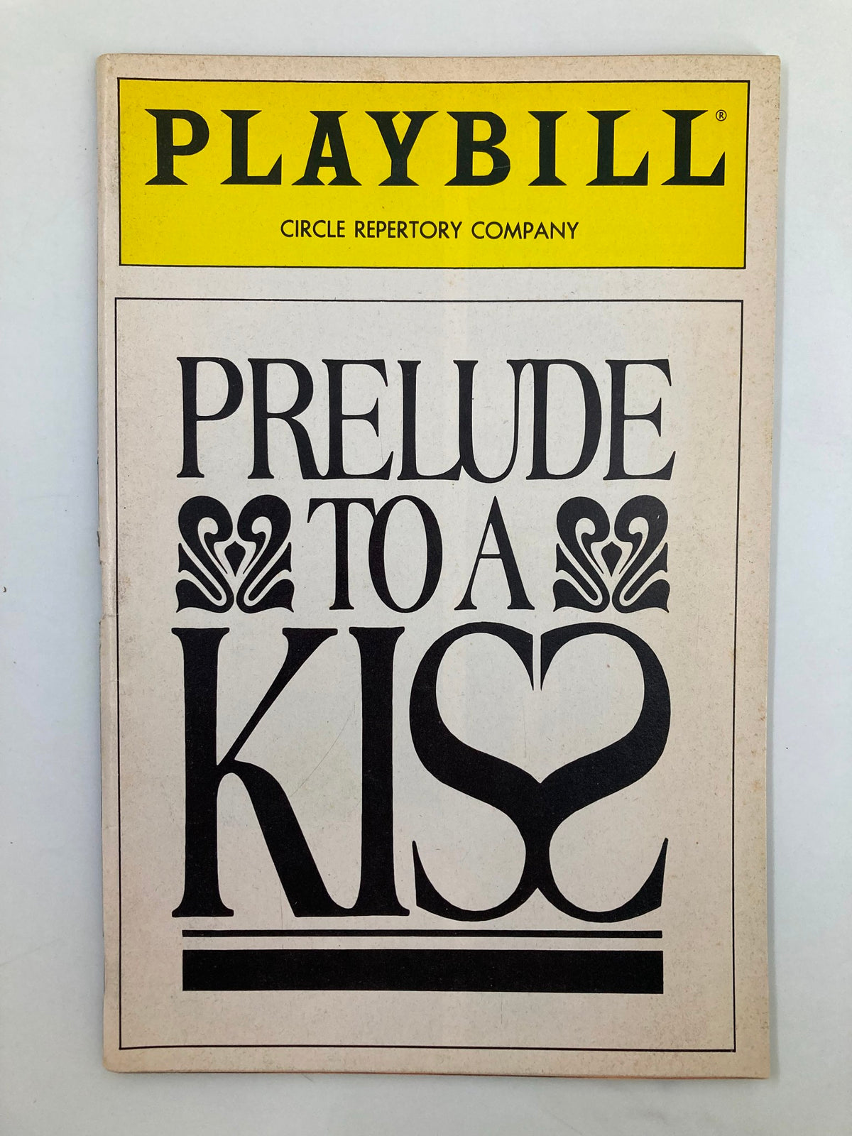 1990 Playbill for Circle Repertory Company's Prelude To A Kiss, featuring bold typography and a heart design.