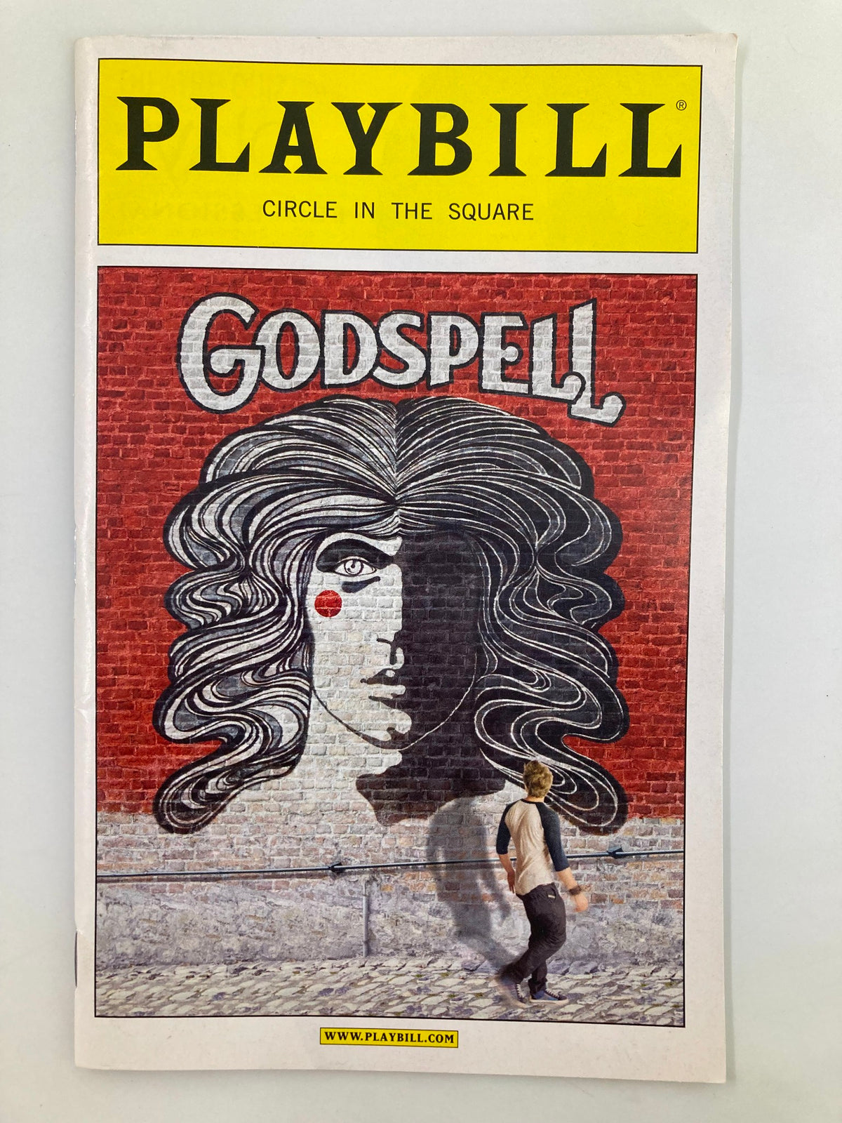 2011 Playbill for Godspell at Circle in the Square featuring artwork of a woman's face; notable performances by Hunter Parrish and Wallace Smith.