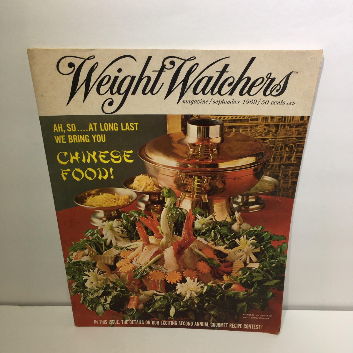 Cover of Weight Watchers Magazine from September 1969, featuring vibrant food imagery with a focus on Chinese cuisine, including a decorative arrangement of fresh ingredients and a copper cooking vessel, highlighting the themes of health and lifestyle in the 1960s.
