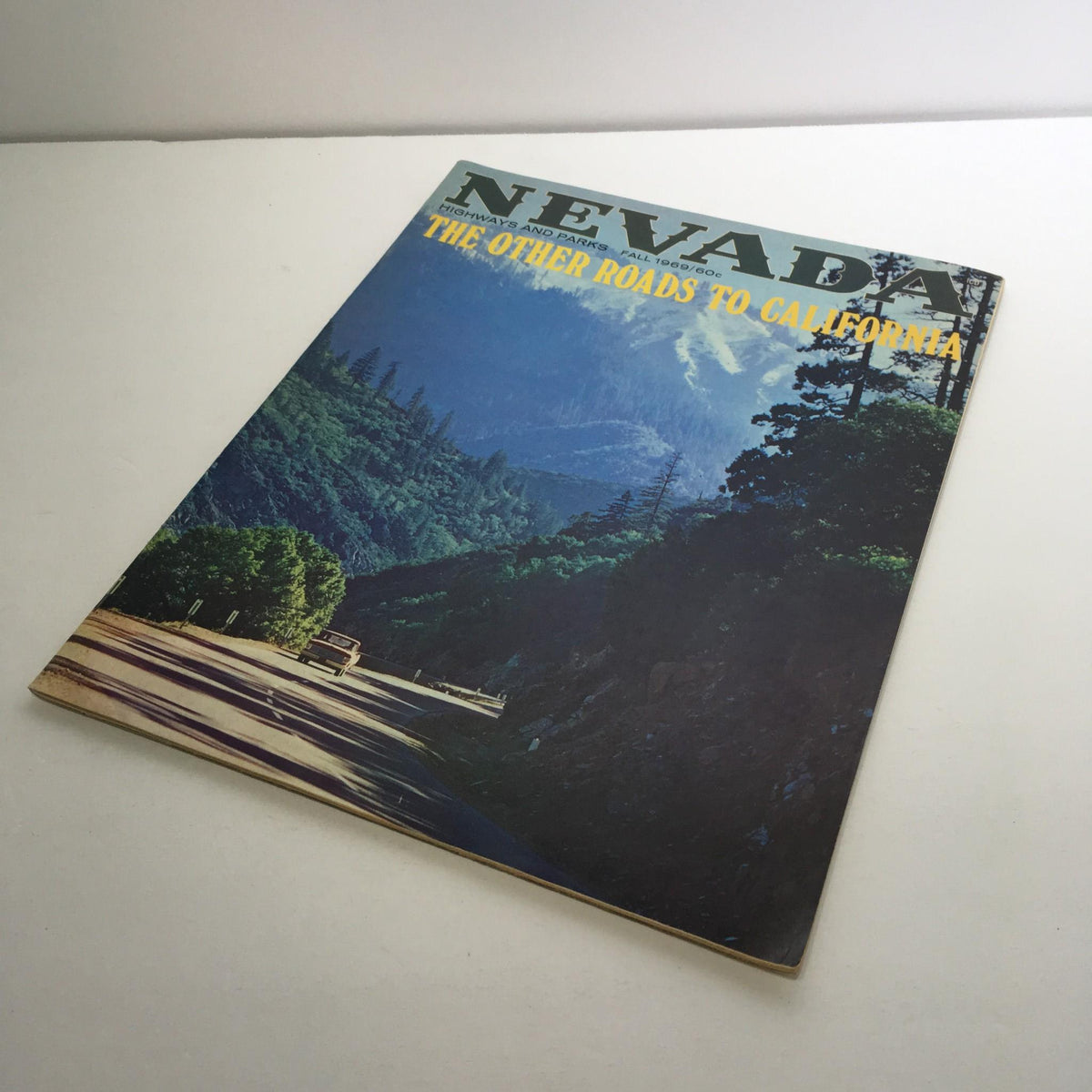Side view of 'Nevada Highways and Parks Fall 1969 - The Other Roads To California Magazine' highlighting its vintage design and nostalgic appeal.