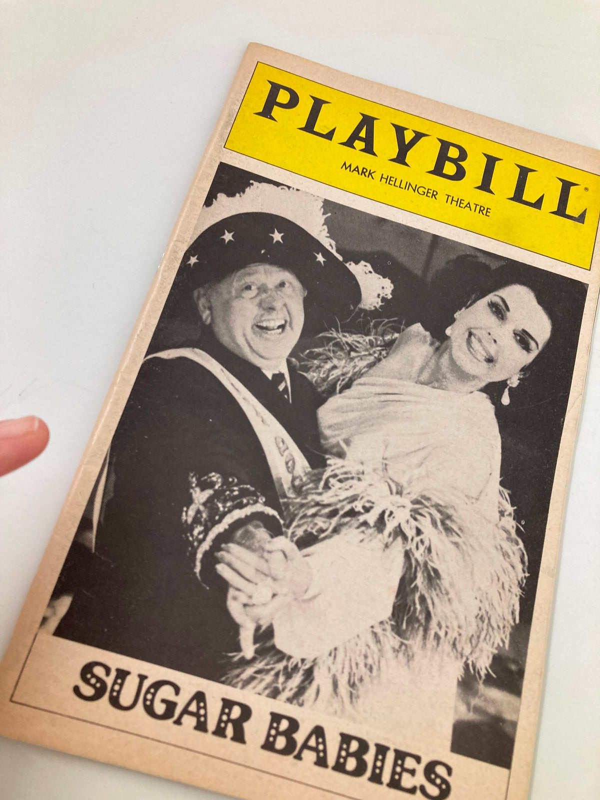Close-up view of the 1981 Playbill from Mark Hellinger Theatre with Mickey Rooney and Ann Miller in Sugar Babies, highlighting the vibrant cover and theatrical theme.