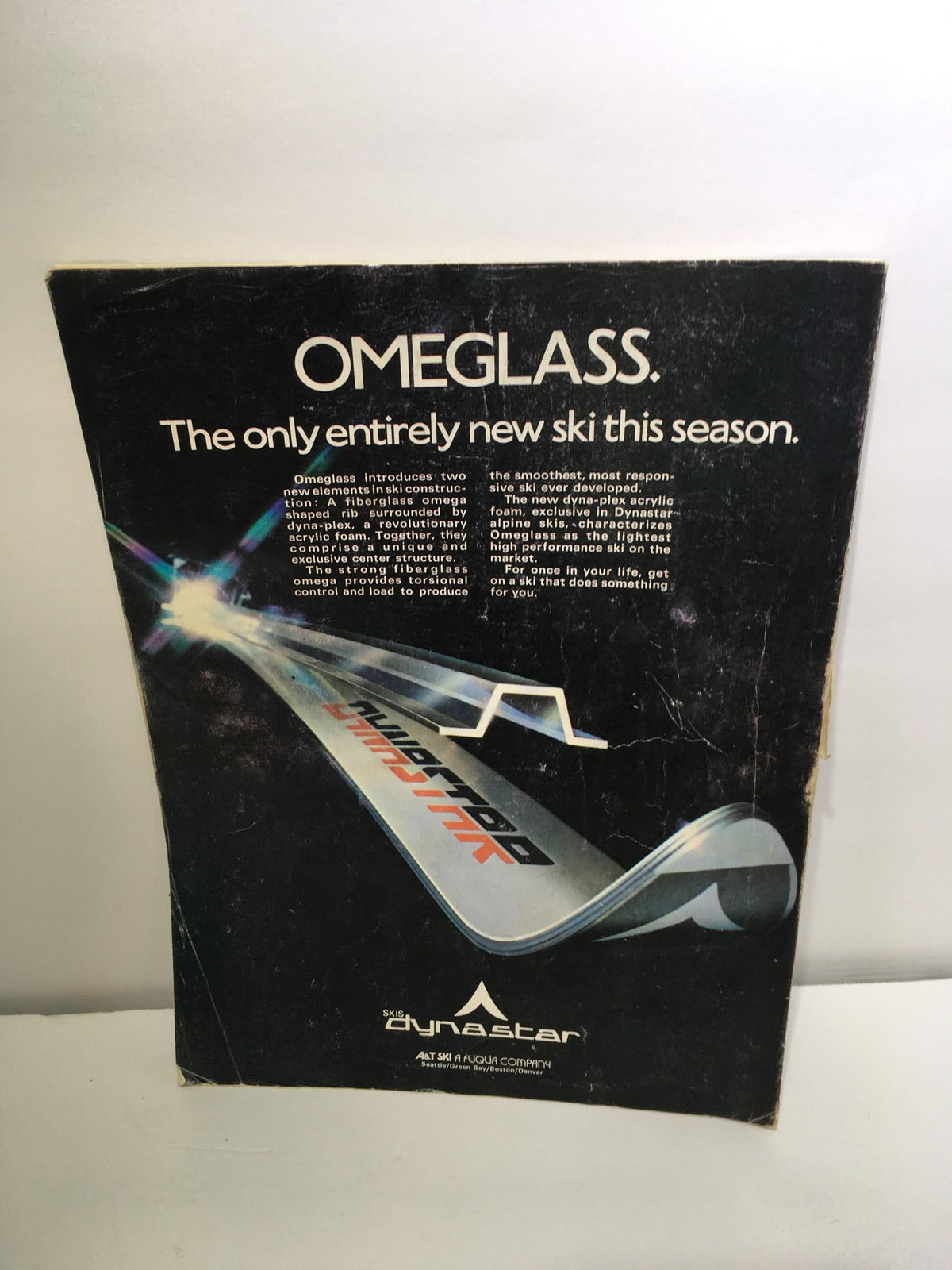 Back cover of Ski Magazine October 1974 featuring an advertisement for OMeglASS skis, highlighting innovative ski technology.