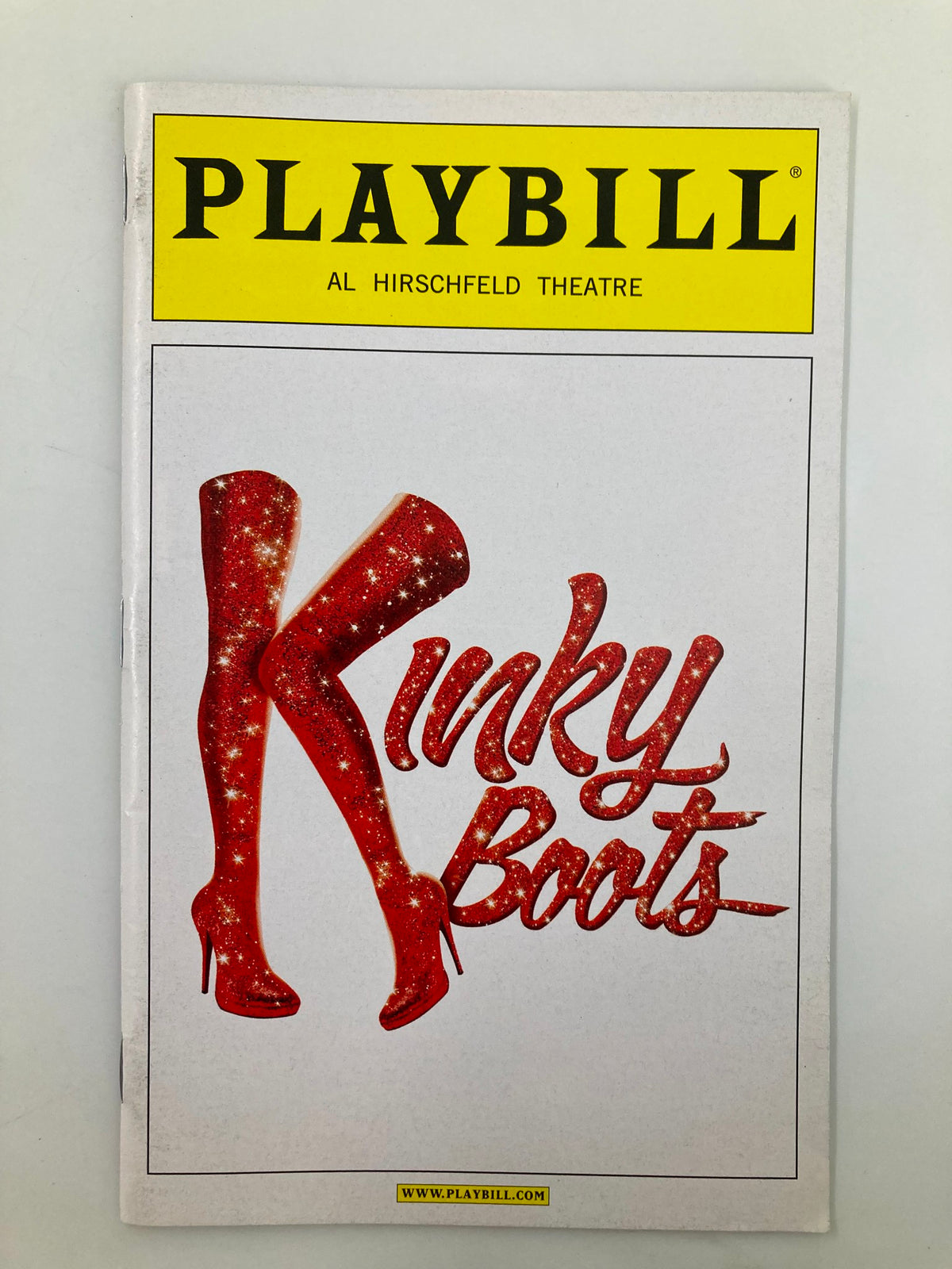 2013 Playbill from the Al Hirschfeld Theatre featuring the title Kinky Boots, showcasing iconic red glittery high-heeled boots on the cover.