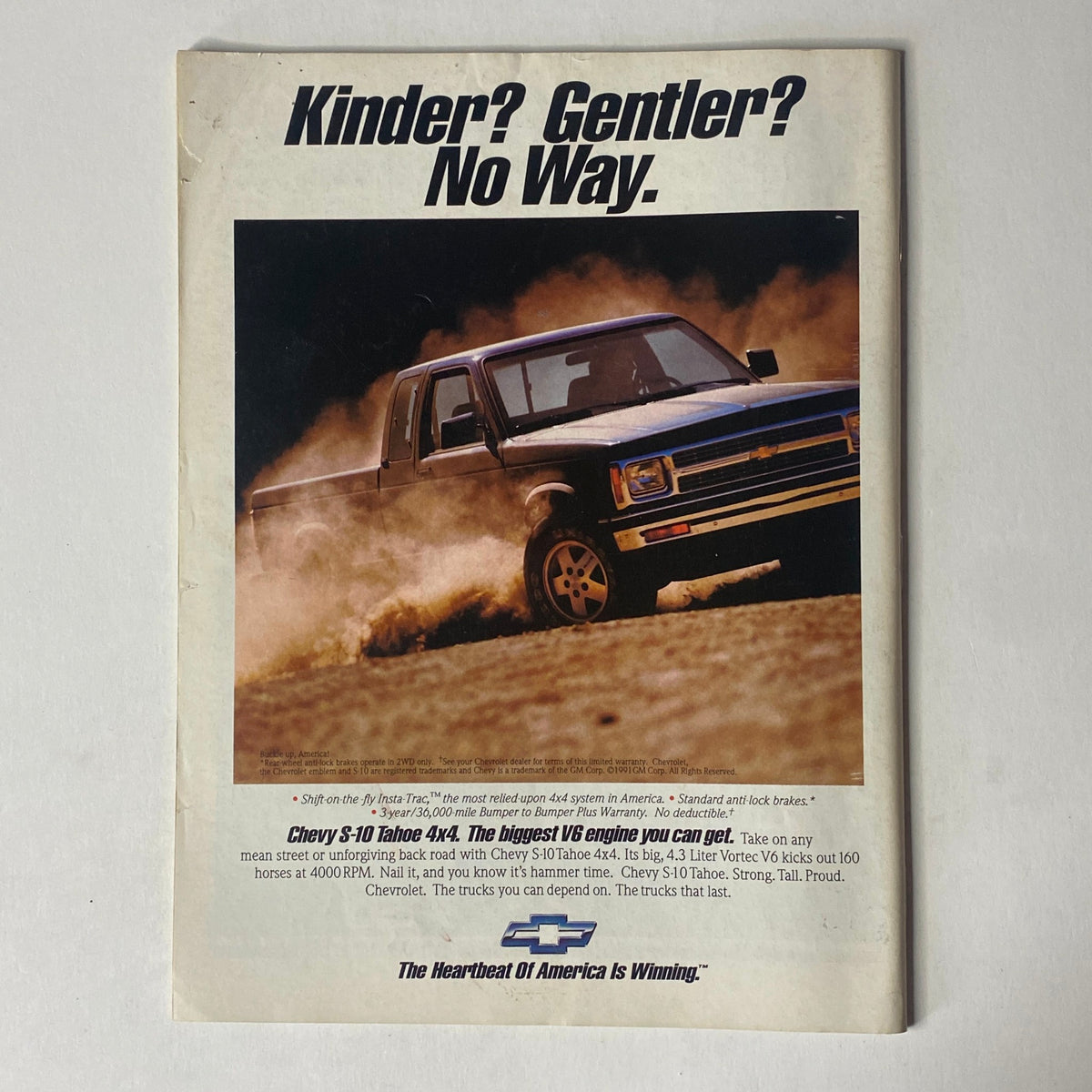 Advertisement for Chevy S-10 Tahoe 4x4 from Sports Illustrated Magazine December 23, 1991, showcasing the truck in action with a powerful slogan.