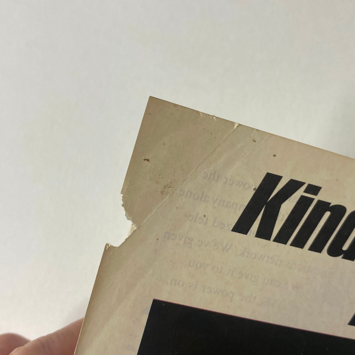 Close-up of the edge of a page from Sports Illustrated Magazine December 23, 1991, showing minor wear and tear, highlighting the vintage nature of the publication.