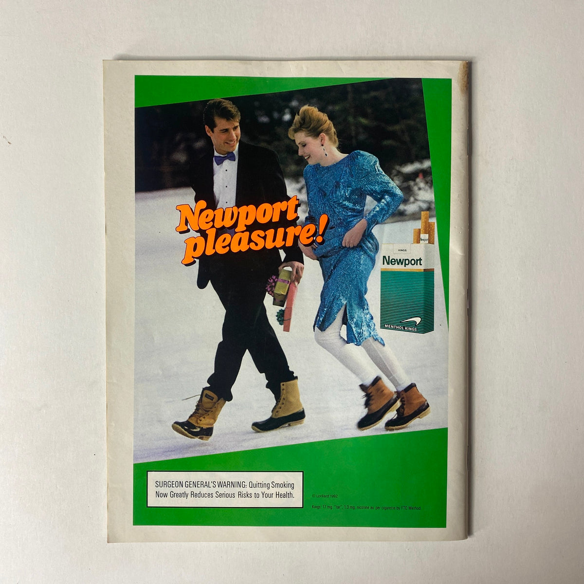 Vintage advertisement from Sports Illustrated Magazine December 28, 1992, showcasing a couple in winter attire promoting Newport cigarettes with the tagline 'Newport pleasure!'.