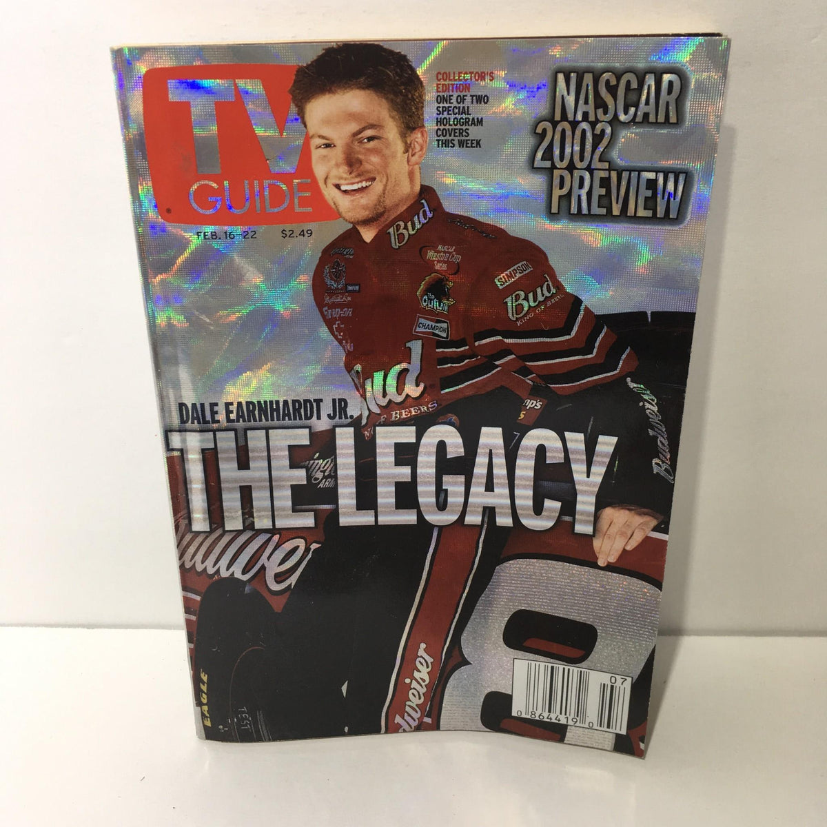 TV Guide February 16-22 2002 featuring Dale Earnhardt Jr. on the cover, showcasing his legacy in NASCAR; vibrant holographic design.