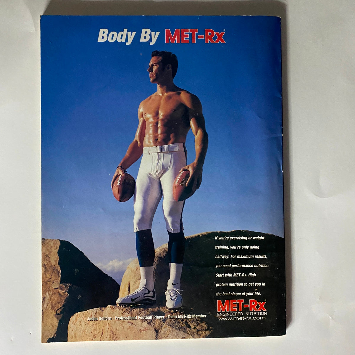 Back cover of Mind & Muscle Power Magazine October 2000 featuring a model promoting MET-Rx with a football theme, highlighting the importance of nutrition in fitness and performance.