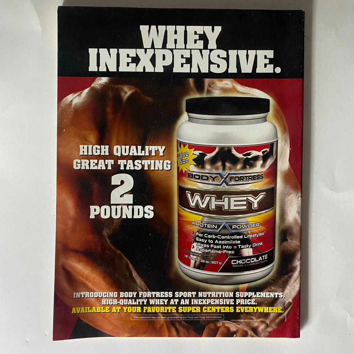 Back cover of AXL Magazine 2002 Vol 1 No. 6 featuring a promotional advertisement for Body Fortress Whey Protein, emphasizing quality and value.