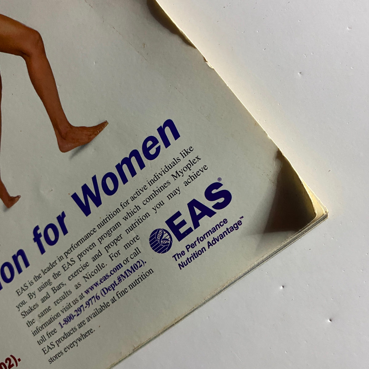 Close-up shot of the fitness advertisement from Muscle Media Magazine September 2000, highlighting the EAS logo and promoting nutrition for active individuals, focused on women's fitness.