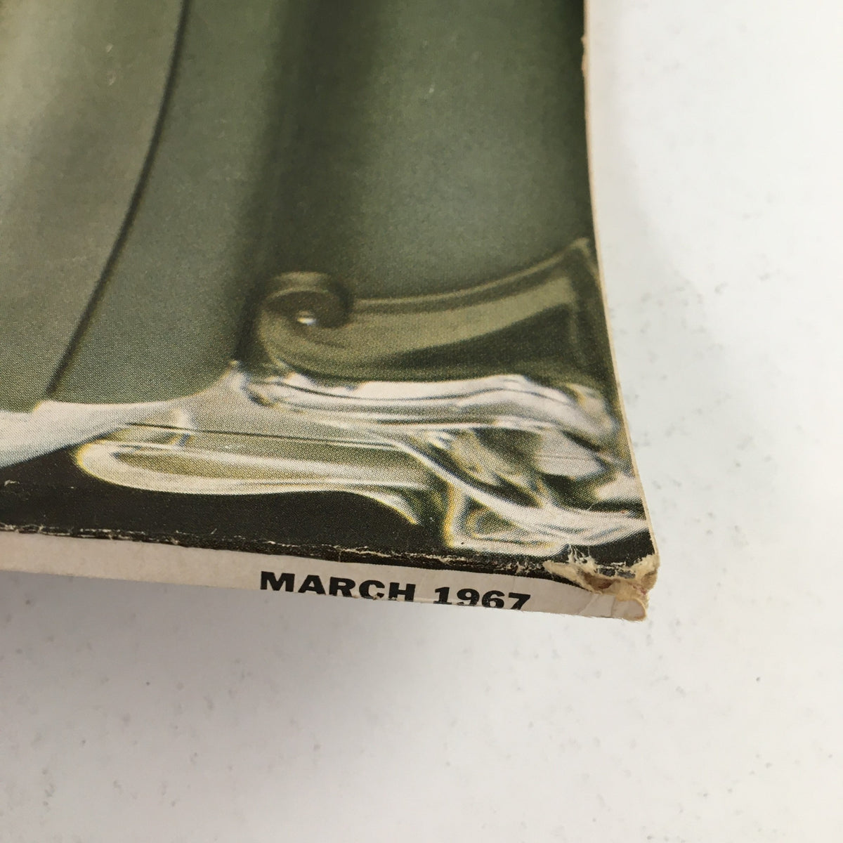 Close-up view of the bottom edge of the Esquire Magazine March 1967, showing wear and the publication date.