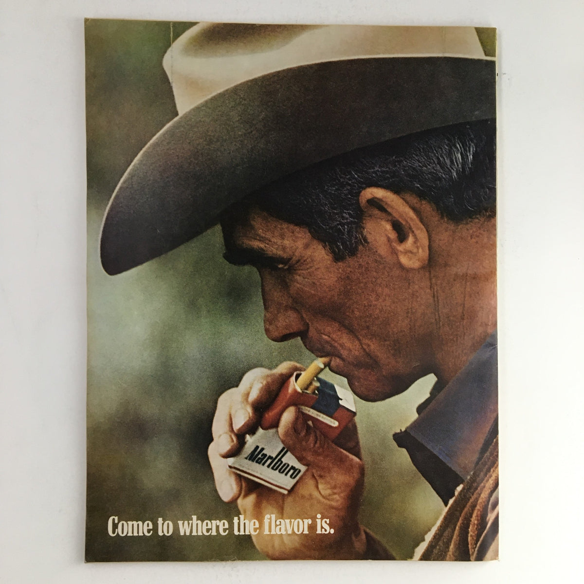 Esquire Magazine February 1969 advertisement featuring a man in a cowboy hat, smoking a cigarette and holding a Marlboro pack, highlighting a classic vintage lifestyle.