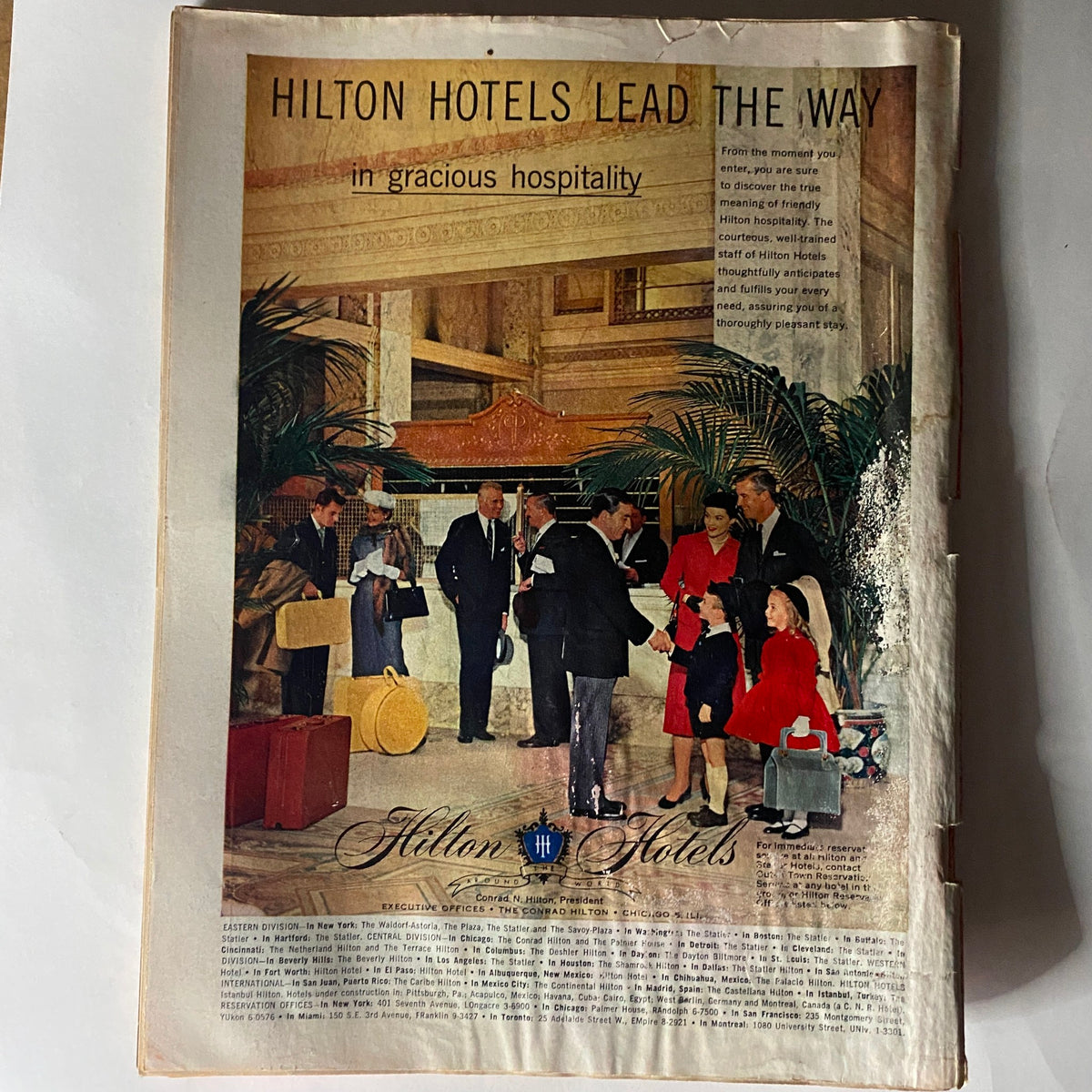 Back cover of VTG Time Magazine May 20, 1957 featuring an advertisement for Hilton Hotels showcasing gracious hospitality.