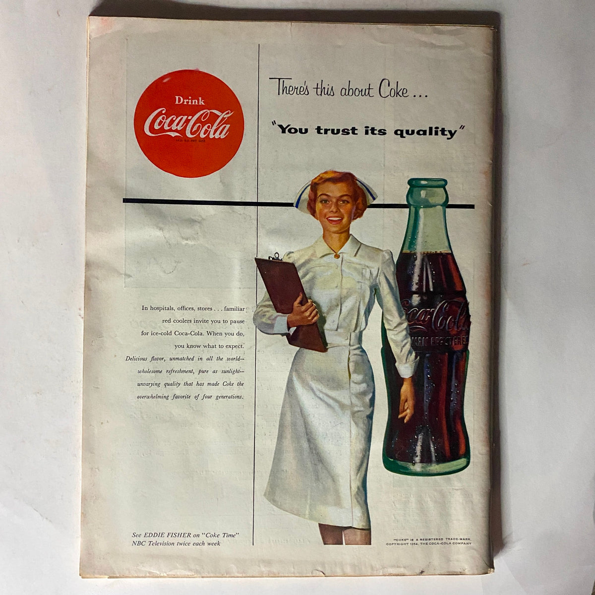 Advertisement page in VTG Time Magazine January 18, 1954 featuring a Coca-Cola advertisement with a nurse promoting quality.