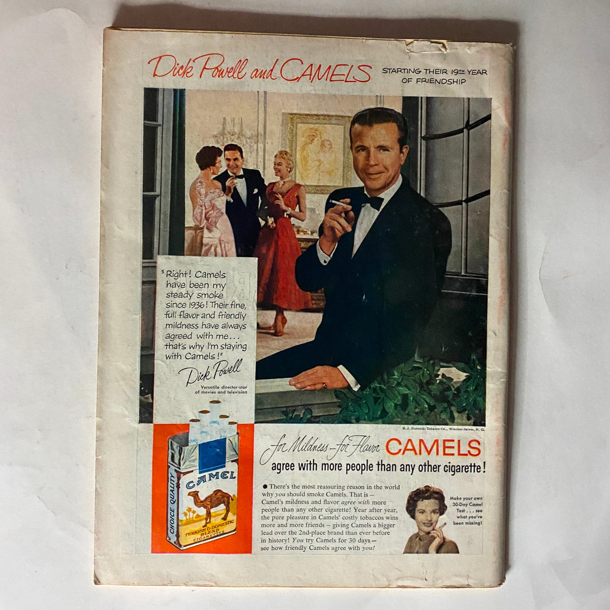 Cover of Vintage Time Magazine March 22, 1954, showcasing an advertisement for Camels featuring Dick Powell. Illustrates mid-century advertising aesthetics and celebrity endorsements.