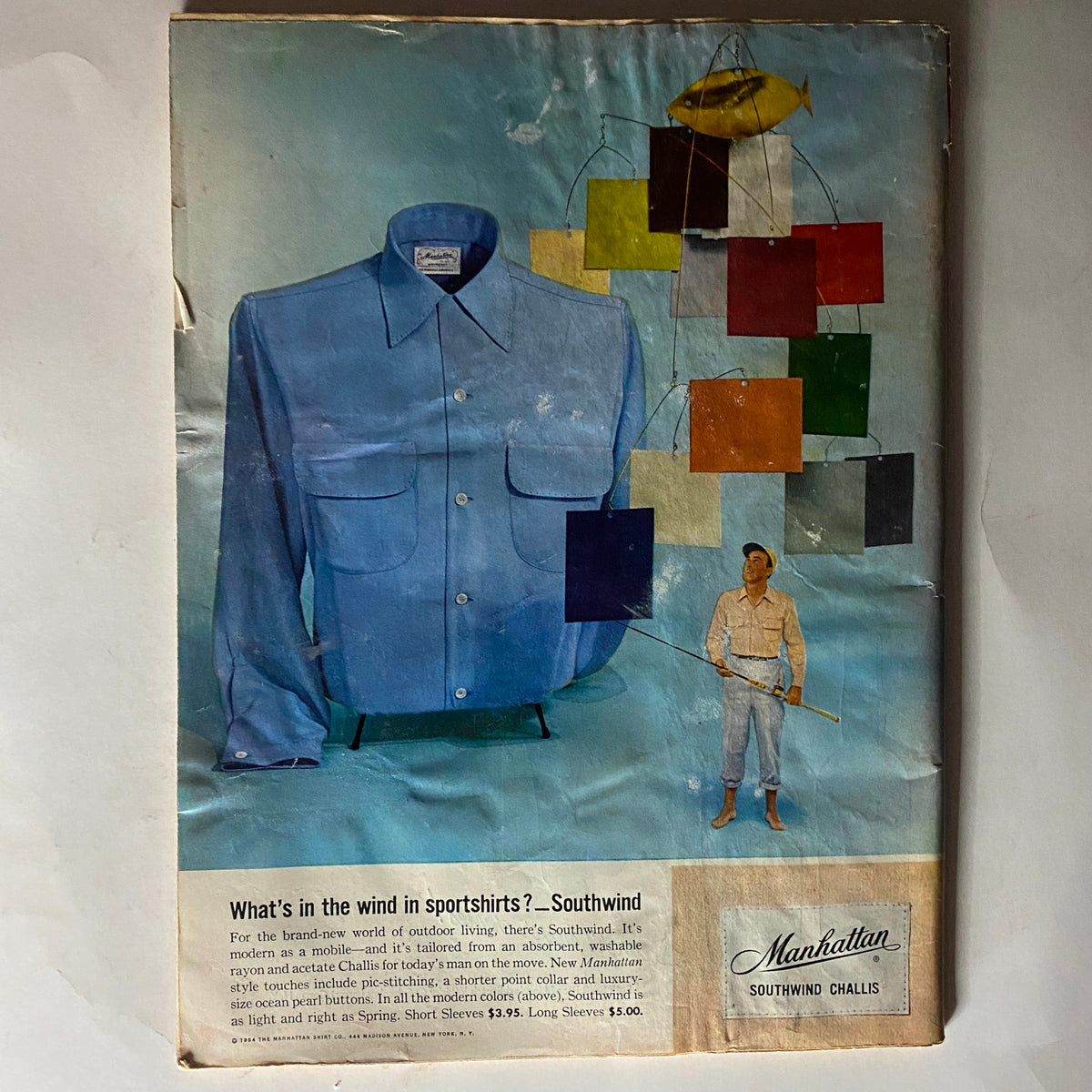 Vintage Time Magazine from April 19, 1954, featuring a striking illustration of a blue sports shirt with a colorful mobile and a figure fishing, embodying mid-century design elements.