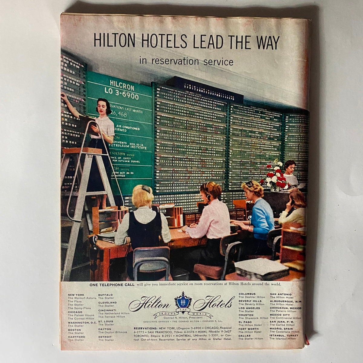 Advertisement page from VTG Time Magazine September 9, 1957 Vol 70 No. 11 promoting Hilton Hotels' reservation service, featuring a busy call center environment.