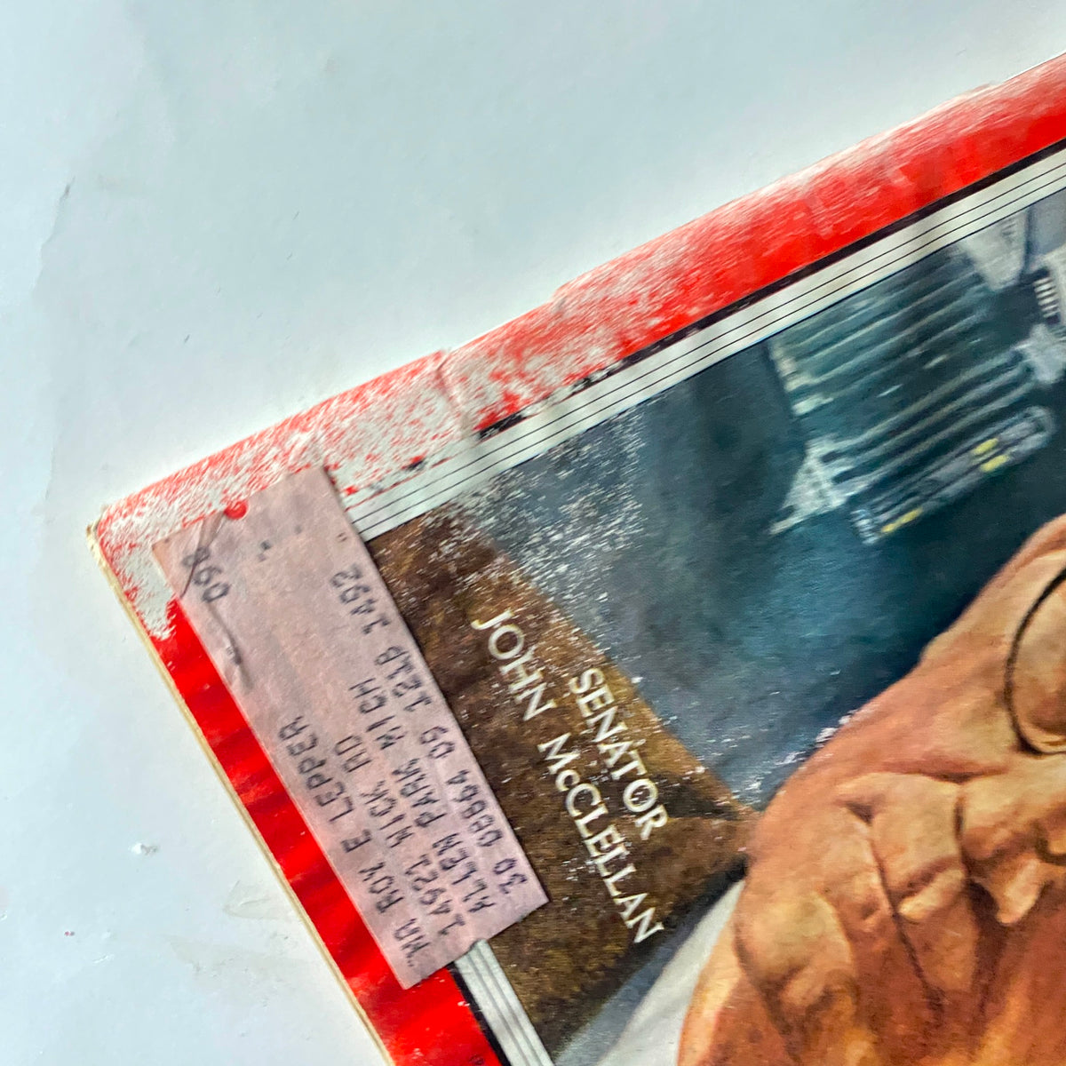 Close-up view of the vintage Time Magazine cover from May 27, 1957, displaying Senator John McClellan's name, showcasing historical significance.