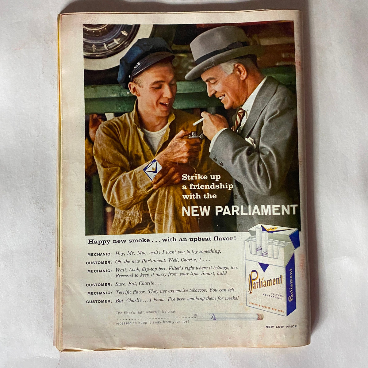 Vintage advertisement from VTG Time Magazine February 18, 1957 promoting New Parliament cigarettes with a scene of camaraderie between two men.