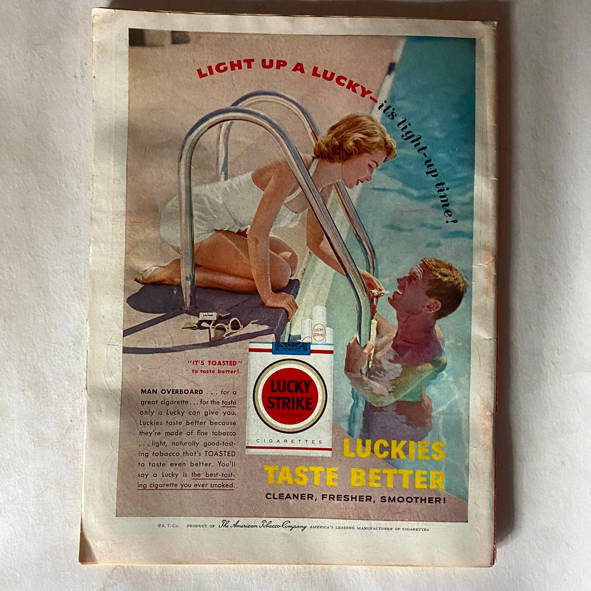 Vintage advertisement from VTG Time Magazine August 20, 1956, promoting Lucky Strike cigarettes with a retro image of a woman by a pool.