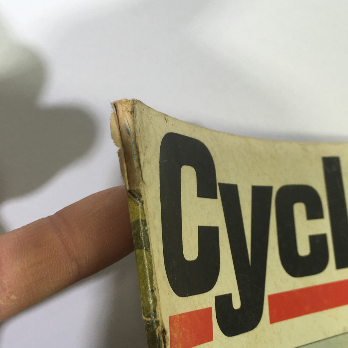 Detail view of the top edge of the Vintage Cycle Magazine May 1968 revealing weathering and wear on the title 'Cycle'.