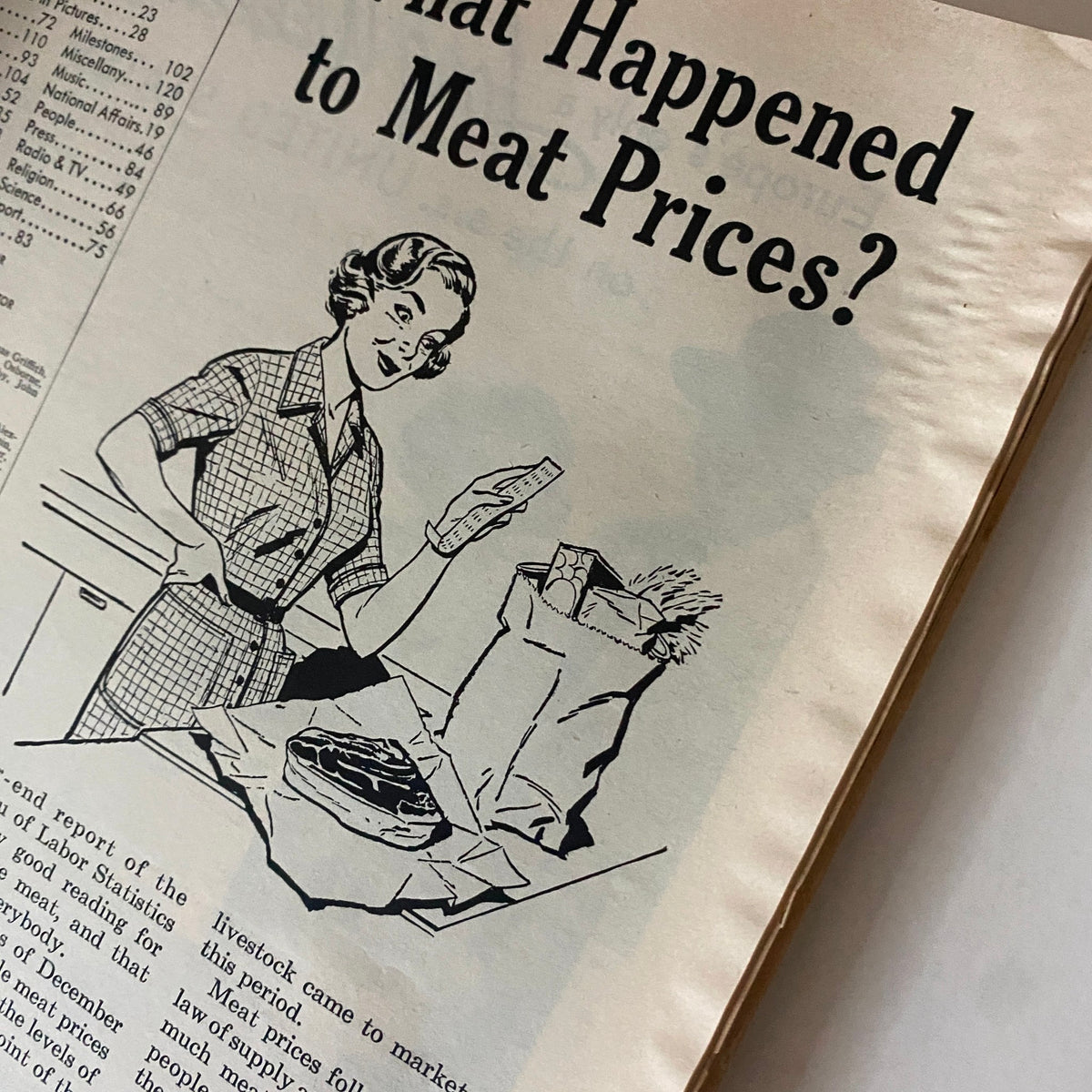 Close-up view of a Time Magazine article from February 16, 1953, titled 'What Happened to Meat Prices?' showing a woman with groceries.