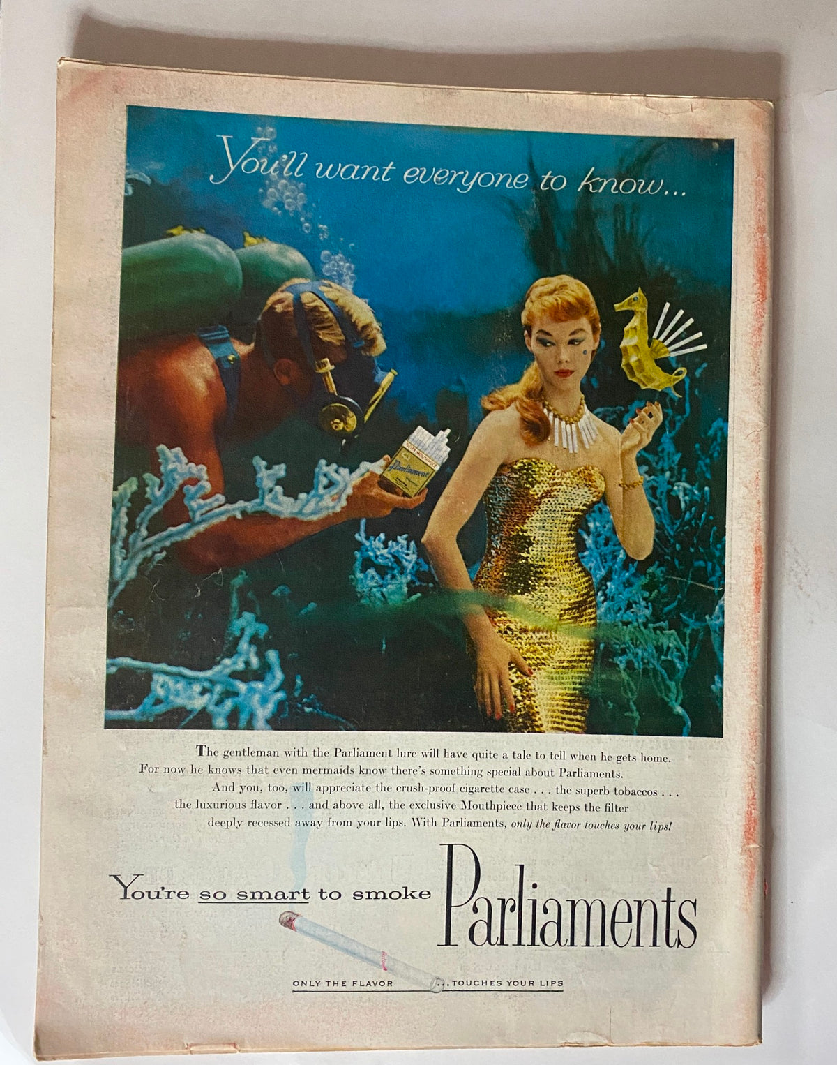 Vintage Time Magazine June 4, 1956 featuring an advertisement for Parliaments cigarettes, showcasing a glamorous woman in a sparkling gold dress underwater with a snorkeler, capturing the essence of mid-20th century advertising.