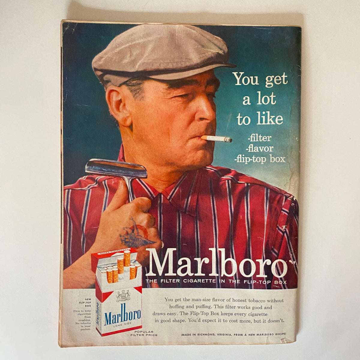 Vintage advertisement from VTG Time Magazine July 30, 1956 showcasing Marlboro cigarettes, featuring a man in a cap and striped shirt.