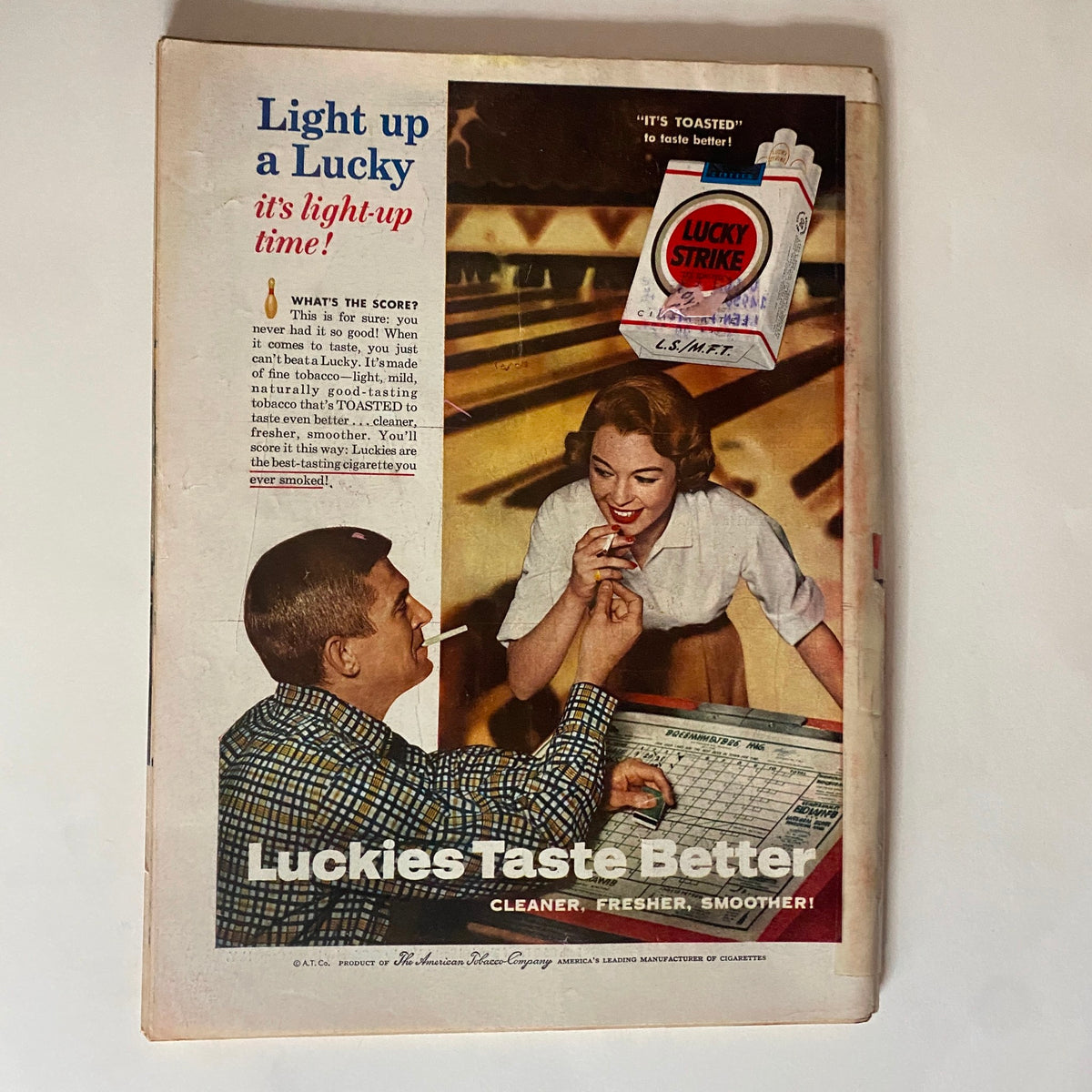 Vintage advertisement from Time Magazine November 12, 1956, promoting Lucky Strike cigarettes with the slogan 'Luckies Taste Better,' featuring a man and woman at a bar.