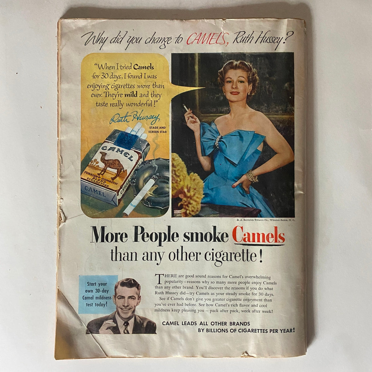Advertisement page in the vintage Time Magazine October 20, 1952, promoting Camels cigarettes with a glamorous model and promotional text.