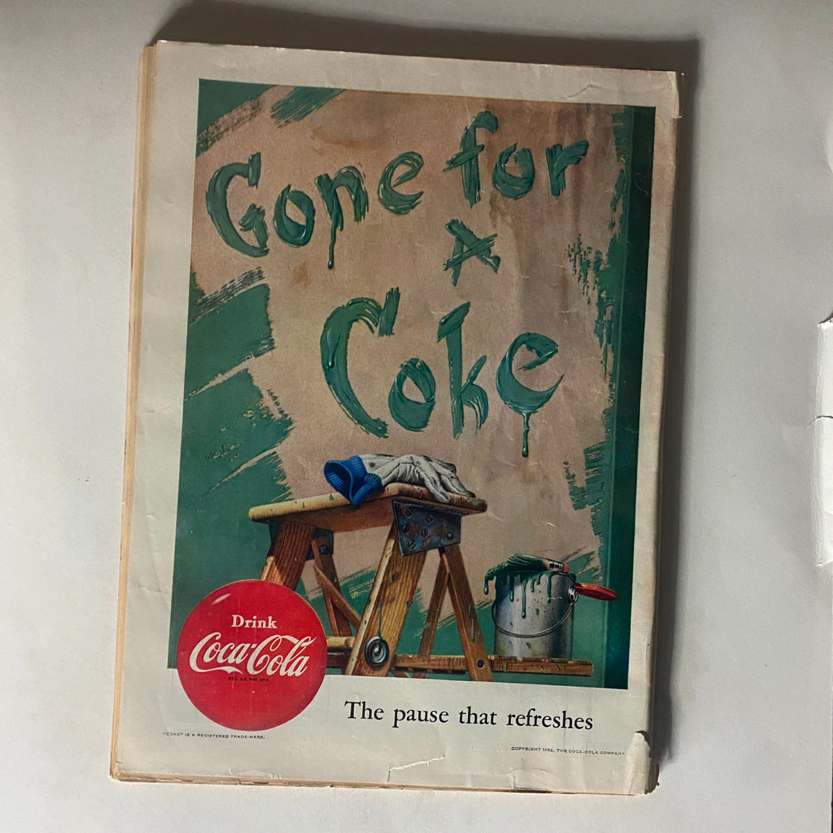 Vintage Time Magazine May 12, 1952 featuring an advertisement for Coca-Cola, showcasing a playful message 'Gone for a Coke' with a backdrop of a painted wall and a wooden ladder.